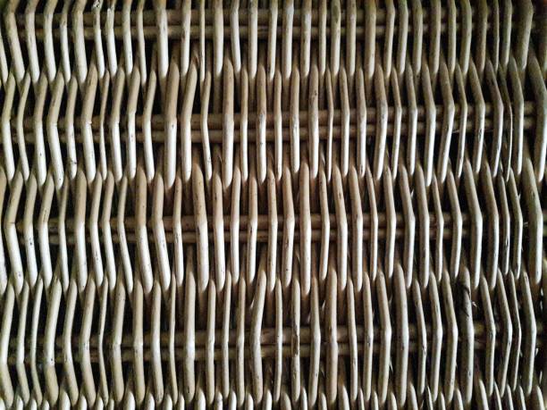 Wicker panel. Full frame. Wicker is a new, flexible wicker rod that, after being peeled and dried, is used to make furniture, baskets, etc. Its use dates back to at least Ancient Egypt (3200–30 BC), for the production of basketry; There are even examples of ceramics with decoration imitating wicker. wood and wire fence designs pictures stock pictures, royalty-free photos & images