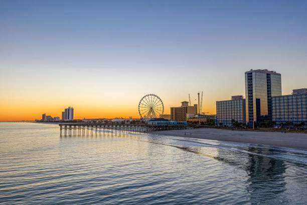 istock there is an oceanfront beach with a ferris wheel in the distance 1937263443