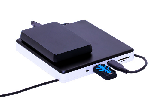 External DVD CD usb burner drive and player with integrated USB interfaces. (connected with hard drive and USB drive), SD TF and micro connections. Clipping path. Computer accessories.
