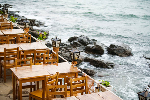 Color image of a terrace from a bar, by the sea, on a rocky coast.