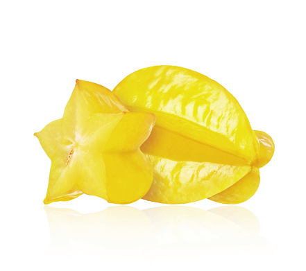 Ripe sliced and whole carambola closeup, isolated on a white background