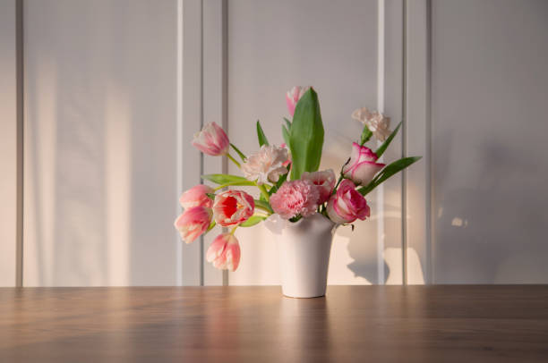 istock pink spring flowers in white ceramic vase in modern home interior 1937306070