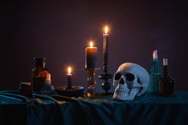 istock scull and burning candles with halloween decor on dark background 1937306085
