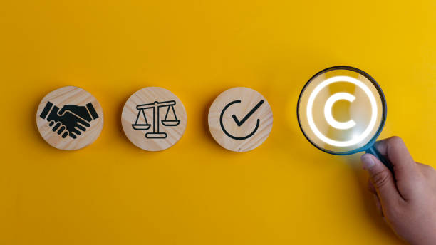 istock Magnifying glass magnifies copyright symbol. Copyright concept, author rights, and patented intellectual property.  trademark license, and Creation ownership against piracy crime. 1937306140