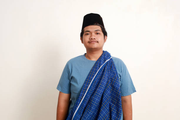istock Asian muslim boy wearing cap standing while looking at the camera 1937320426