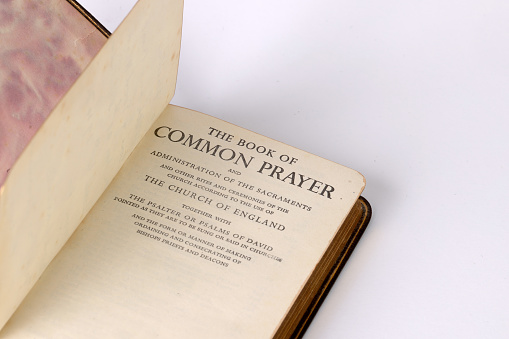 Common Prayer book open on a plain background
