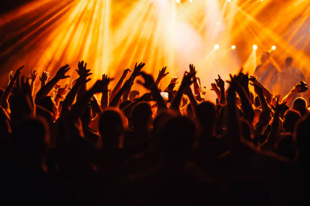 istock Silhouettes of crowd hands on a rock concert. 1937327904