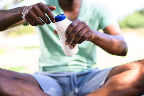 istock Close up unrecognisable young man opening flavoured milk bottle 1937336487