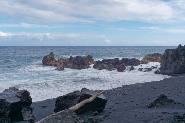 istock Coastal rocks with ocean waves. Kehena Black Sand Beach, Hawaii 1937338070