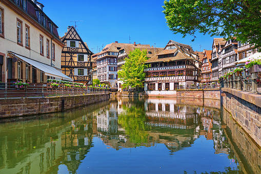 Alsace, France. Traditional half-timbered houses on the canals district La Petite France in Strasbourg in summer. UNESCO World heritage site.