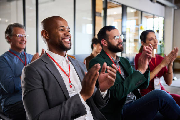 istock Smiling young businessman and coworkers clapping during an office presentation 1937360775