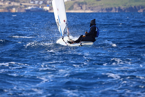 Bodrum,Turkey. 13 January 2024: Optimist sailboat during a training session in the sea