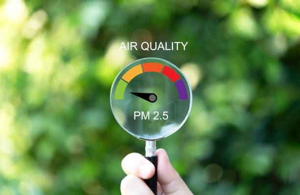 istock Hand holding magnifier glass with good air quality indicator scale on greenery background which check PM 2.5 or particulate matter 2.5 micron for air pollution effect to health and lifestyle concept. 1937371924