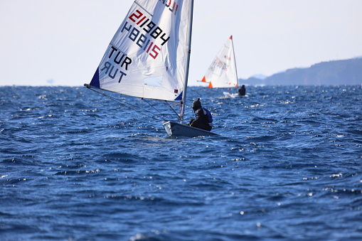 Bodrum,Turkey. 13 January 2024: Optimist sailboat during a training session in the sea