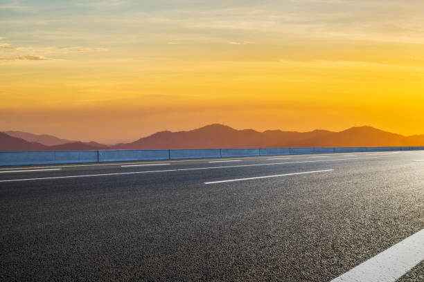 istock Asphalt highway and beautiful mountain with sky clouds at sunset 1937384083
