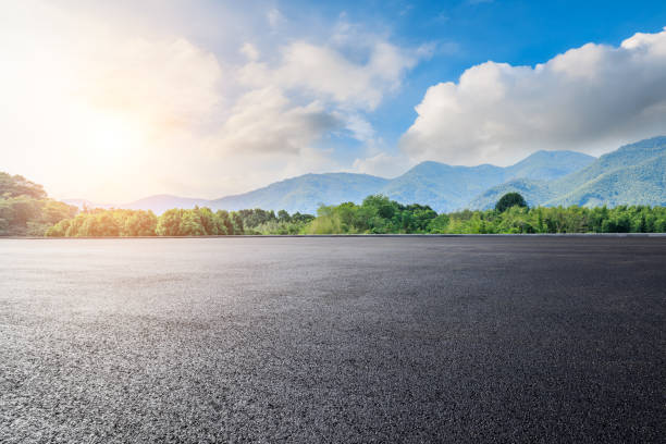 istock Asphalt road and green mountain background 1937398809