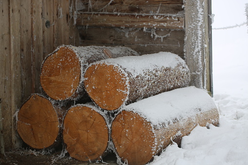 Cottage in the winter with overcast skies and after a fresh snowfall