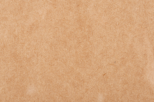 Brown corrugated cardboard paper texture background. Kraft paper for design background. Brown recycles paper sheet. Top view.