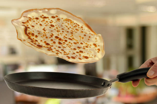 Make jumping a crepe from crepe maker closeup