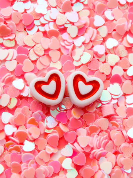 istock Heart-shaped beads on pink glitter 1937411872