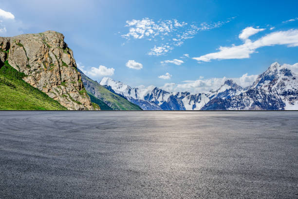 istock Asphalt road square and snow mountain natural landscape under blue sky 1937414204