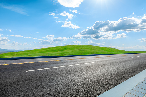 Road and green grass background