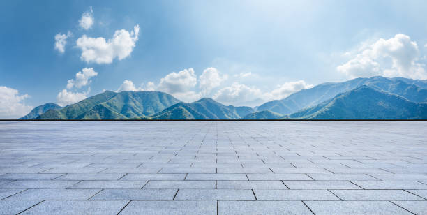 istock Empty square floor and green mountain nature landscape under blue sky 1937415755