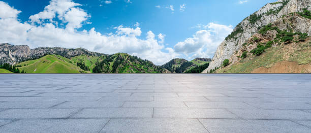 istock Empty square floor and green mountain nature landscape under blue sky 1937415809