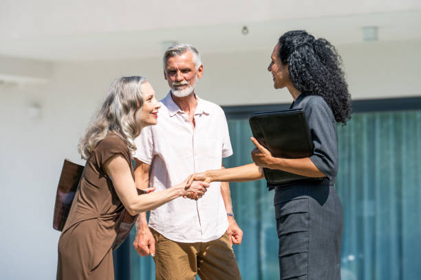 istock Real estate agent and couple handshake 1937435183
