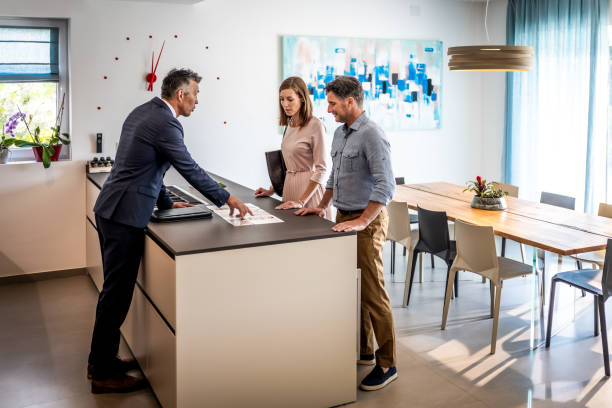 istock Couple chatting at real estate showing 1937435532