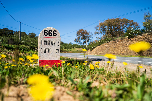 Road milestone indicating 666th kilometer on famous national road N2 going across Portugal, Almodovar