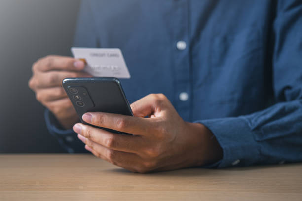 istock Businessman using mobile phone and holding credit card. Digital information technology and cyber security concept. 1937458836