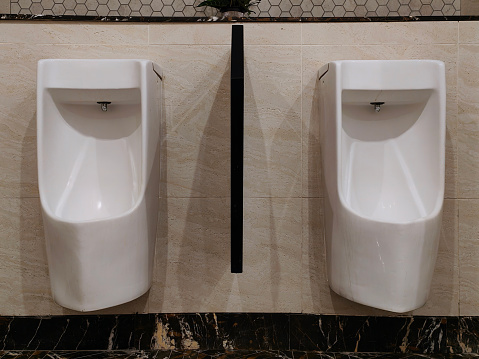 Wall mounted men's urinal in toilet