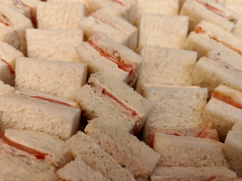 Abundance of tuna sandwich with tomato slices ready for buffet