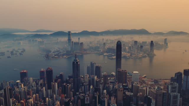 Aerial slide right Hong Kong cityscape at sunrise