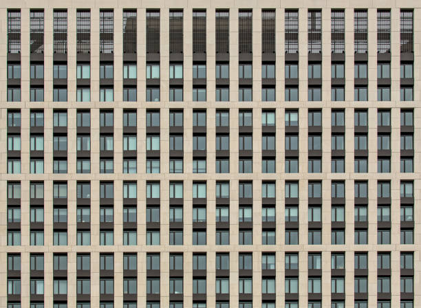 istock building window detail (grid of windows in modern residential building, apartment complex, coop, condo, condominium) abstract symmetrical pattern in housing flats, perpendicular lines intersecting 1937526878