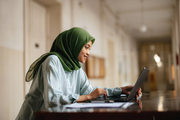 istock Portrait of a Beautiful Female Indonesian Student Using a Laptop Computer 1937527981
