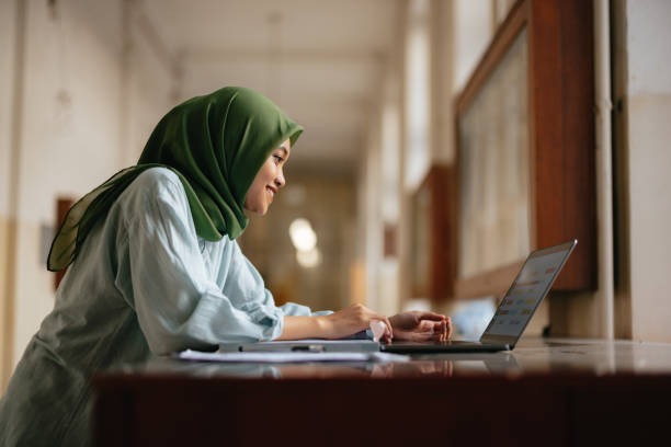 istock Portrait of a Beautiful Female Indonesian Student Using a Laptop Computer 1937527988