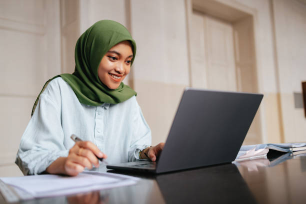 istock Portrait of a Beautiful Female Indonesian Student Using a Laptop Computer 1937528007