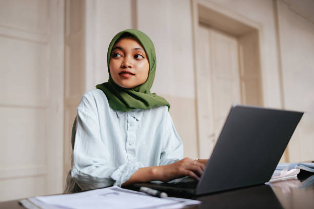istock Portrait of a Beautiful Female Indonesian Student Using a Laptop Computer 1937528524