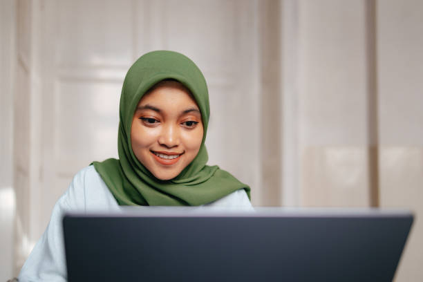 istock Portrait of a Beautiful Female Indonesian Student Using a Laptop Computer 1937529047