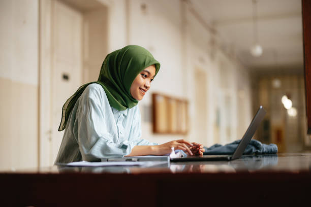 istock Portrait of a Beautiful Female Indonesian Student Using a Laptop Computer 1937529051