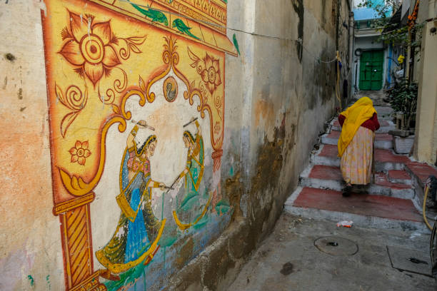 Udaipur, India - January 8, 2024: A woman dressed in shari walking down a street in Udaipur, Rajasthan, India.
