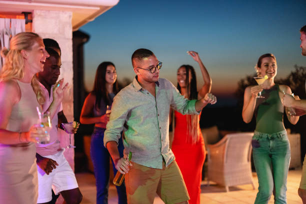 istock Diverse Friends Having An Evening Pool Party At A Vacation Villa 1937534506