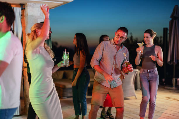 istock Diverse Friends Having An Evening Pool Party At A Vacation Villa 1937535614