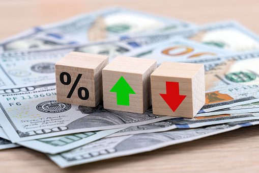 United States central banking is changing interest rates concept with percentage symbol and up down arrow symbol on the wooden cube