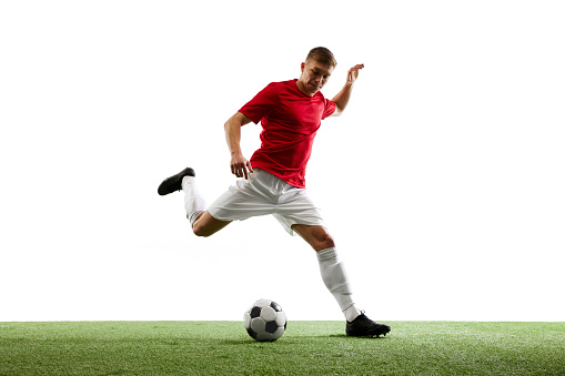 Precision in Motion. skilled football player delivers perfect airborne pass, showcasing unparalleled precision against white background with lush green grass. Concept of sport, world cup season, match