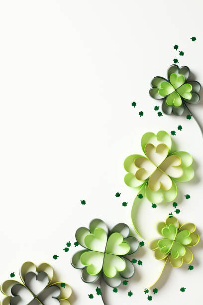 istock Abstract St Patrick Day background with paper clover leaves and confetti on white table. Top view. Flat lay. 1937550205