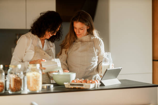 istock Mother and Daughter Cooking Together 1937562772