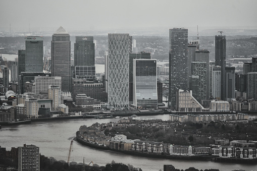 Canary Wharf Building complex in East London, England, United Kingdom, Great Britain – January 2024: An aerial photograph showing the urban panorama view/city skyline and River Thames was taken in the heart of the financial district of the City of London. This photo was captured in the London's East End.